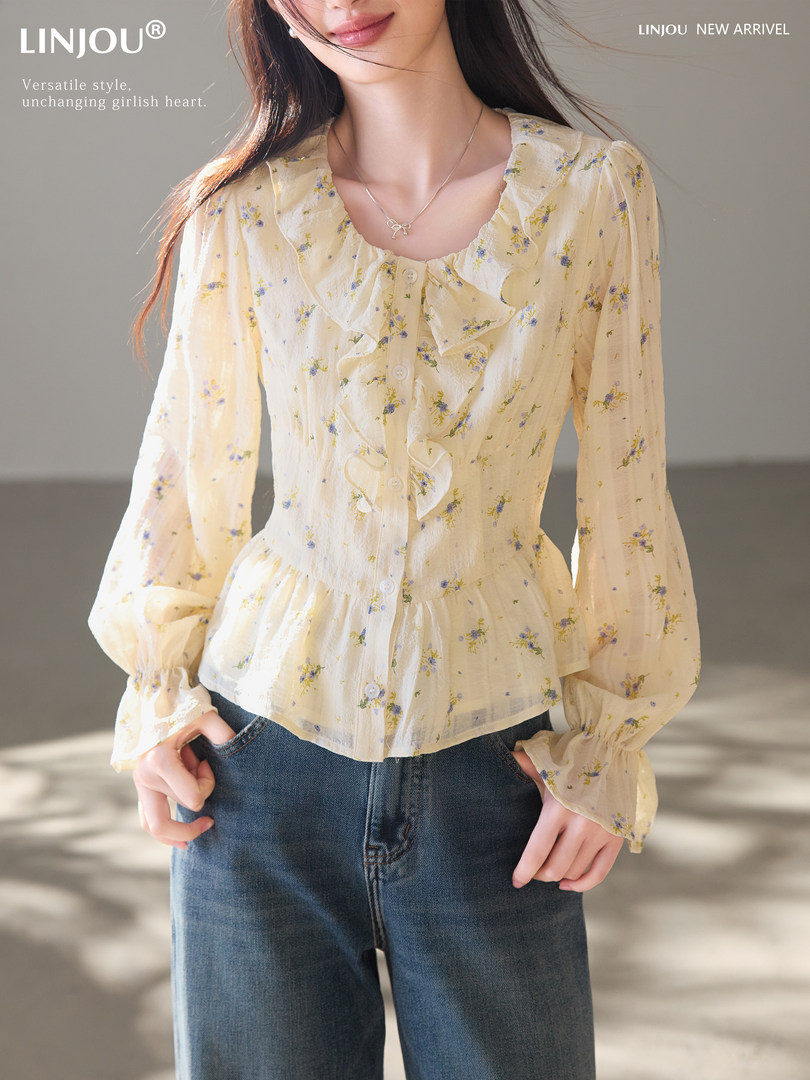 Model wearing a cream floral ruffled long-sleeve blouse with jeans