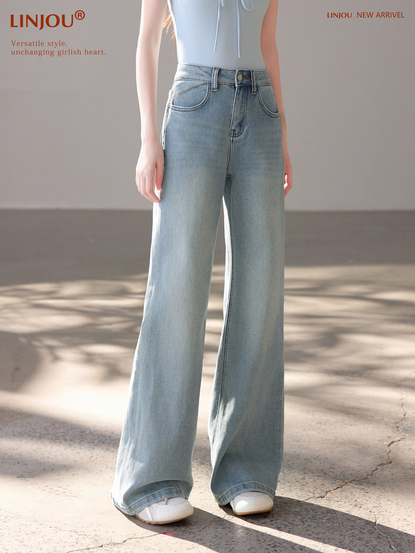 Light wash wide-leg jeans worn by a model with white shoes