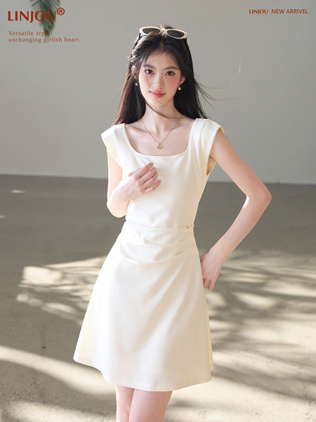 Model wearing a white sleeveless dress with a flared skirt