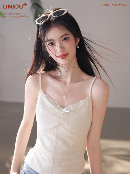 Woman wearing a white lace camisole top