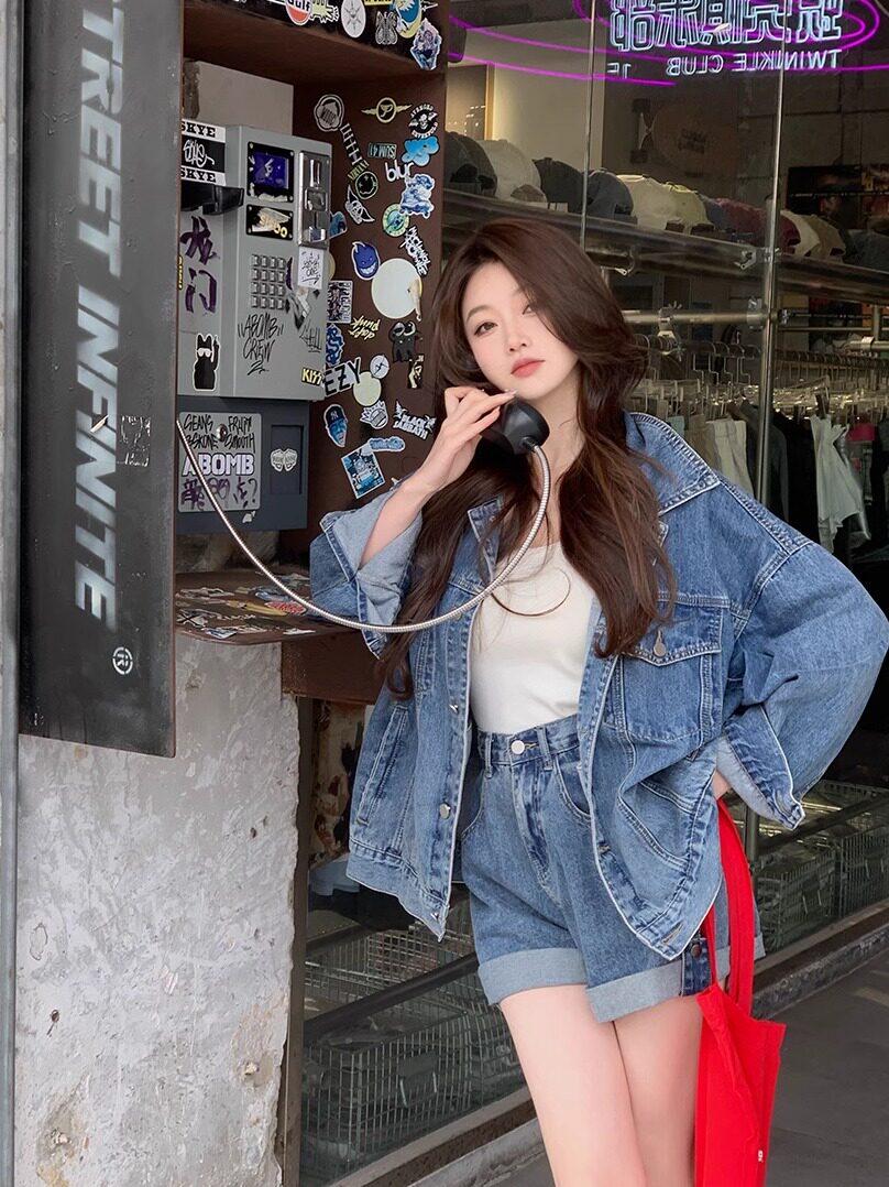 Woman wearing a blue denim jacket and matching shorts set