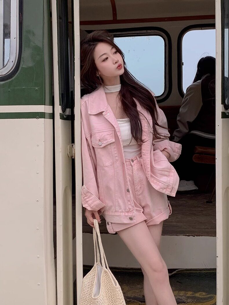 Woman wearing a pink denim jacket and shorts set