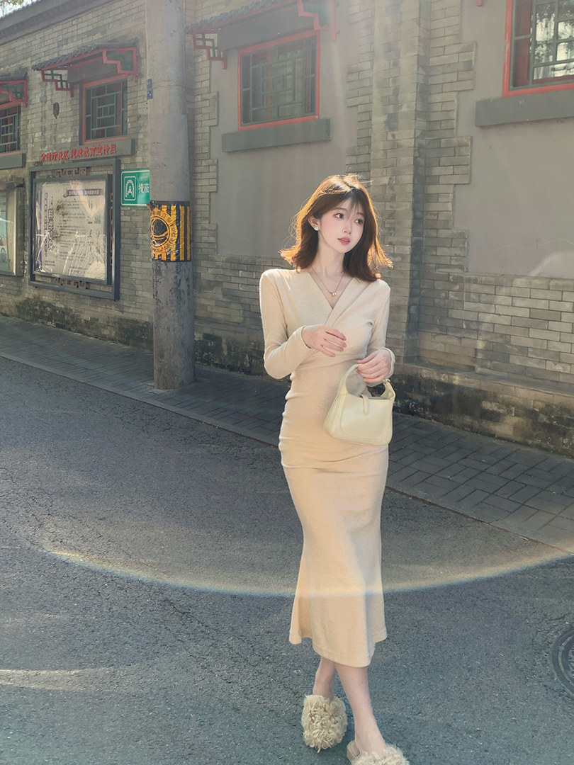 Beige long-sleeve knit midi dress worn by a model