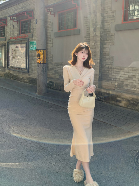 Beige long-sleeve knit midi dress worn by a model
