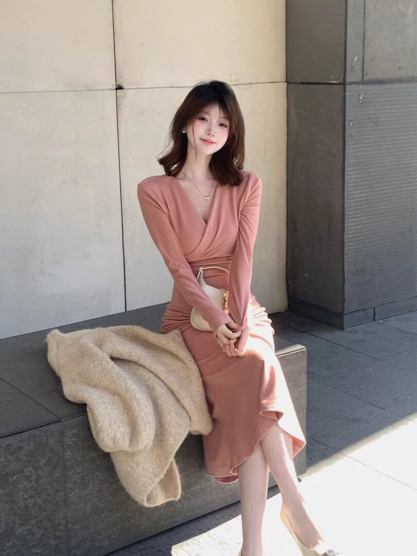 Woman wearing a pink long-sleeve wrap midi dress
