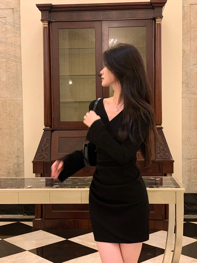 Black long-sleeve fitted mini dress worn by a model