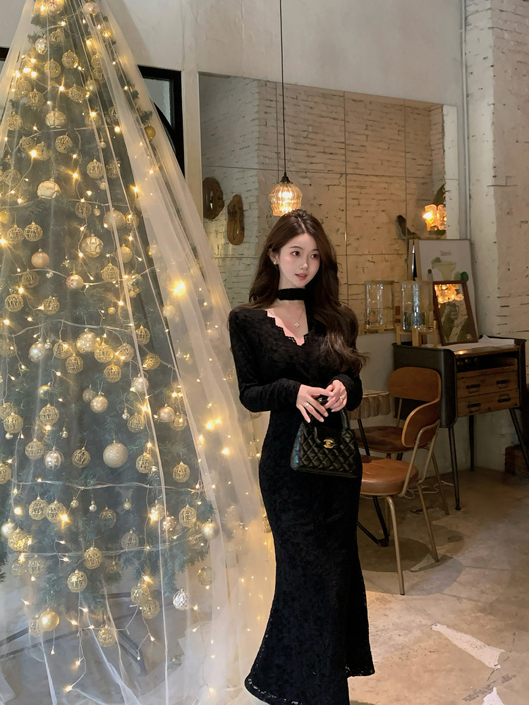 Black long-sleeve fitted dress worn by a woman