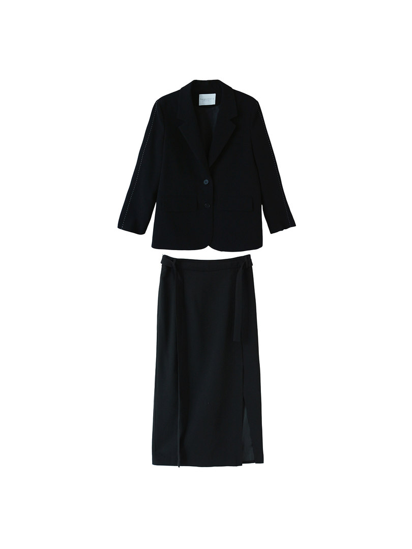 Black two-piece blazer and skirt set laid flat on a white background