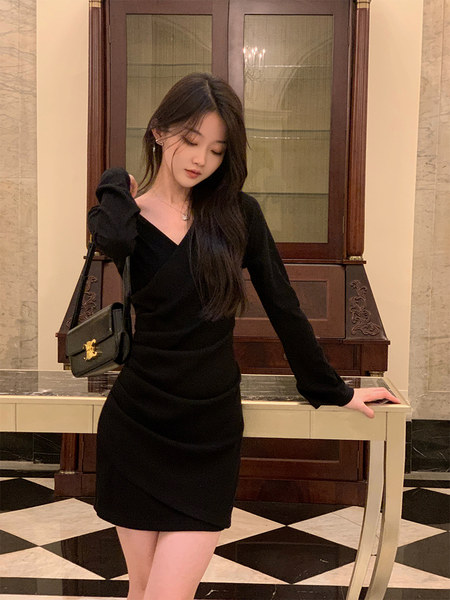 Black long-sleeve mini dress worn by a model