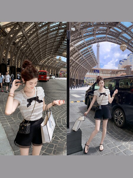 Model wearing a white ruffled short-sleeve top with black shorts outdoors