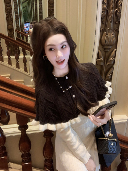 Woman wearing a black and white elegant outfit with a handbag