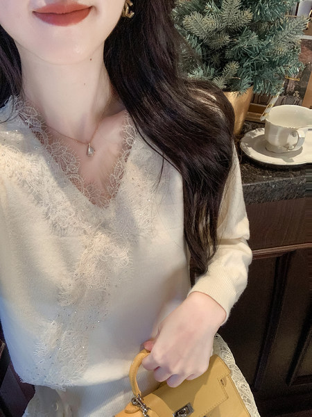 Cream lace-trim knit sweater worn by a model holding a yellow handbag