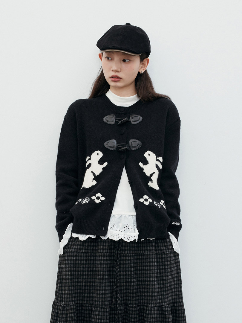 Black knit cardigan worn by a model with white graphic details
