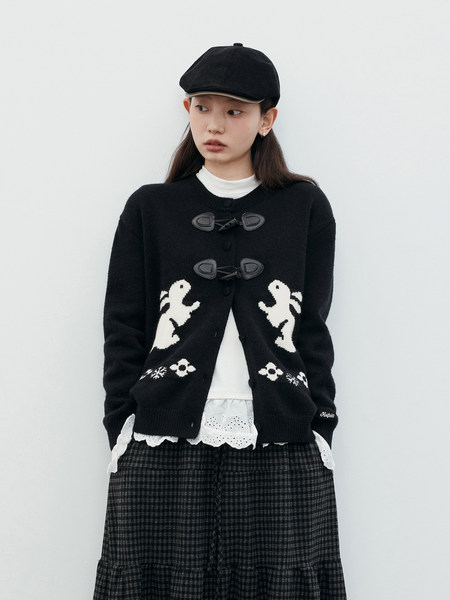 Black knit cardigan worn by a model with white graphic details