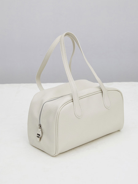White leather handbag with double handles on a plain background