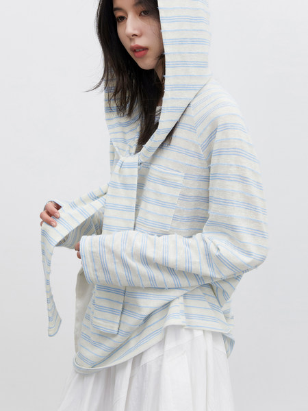 Model wearing a light striped hooded top
