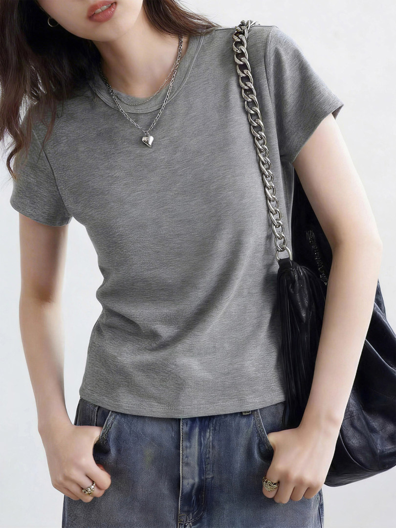 Gray short-sleeve t-shirt worn with jeans and a shoulder bag