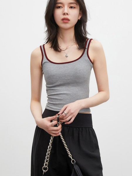 Model wearing a gray ribbed tank top with burgundy trim and black skirt