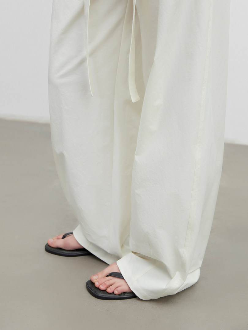 White wide-leg pants worn with black sandals