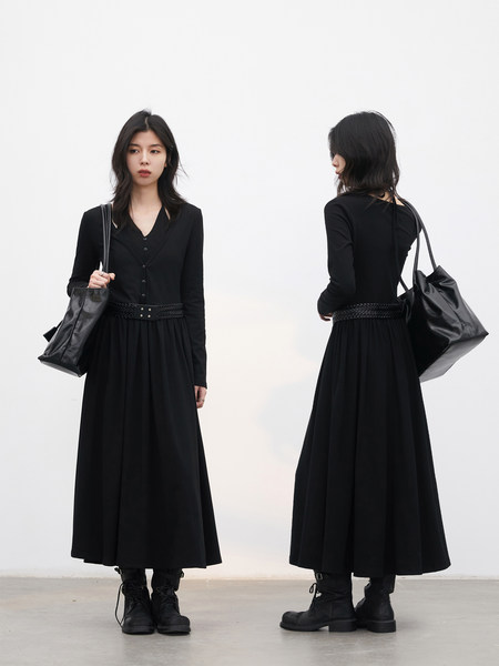 Black long-sleeve midi dress worn by a model with a braided belt and black boots