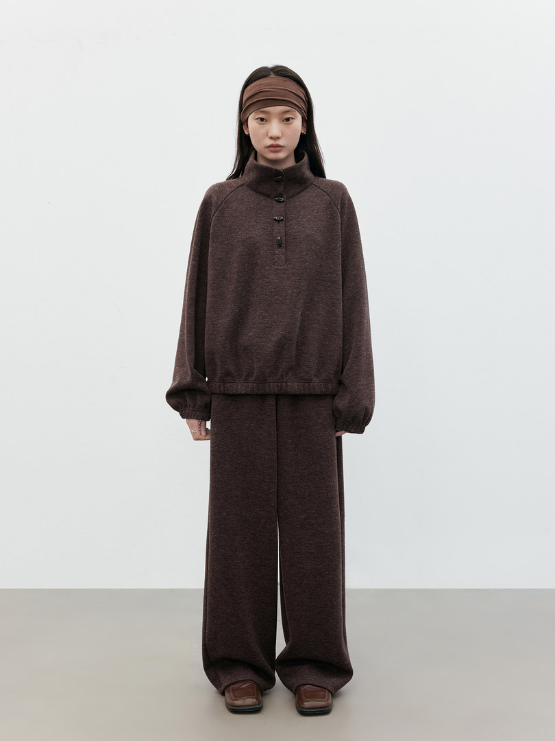 Model wearing a brown two-piece knit lounge set with headband and loafers