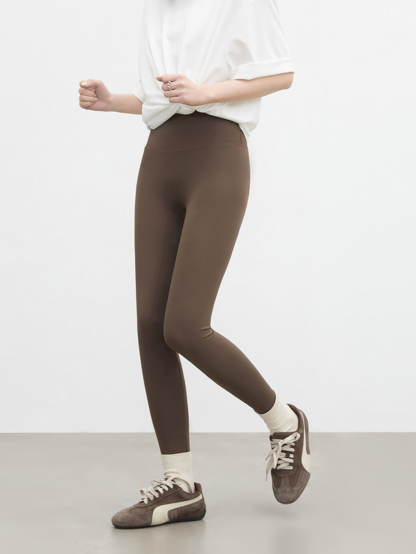 Model wearing brown leggings with sneakers