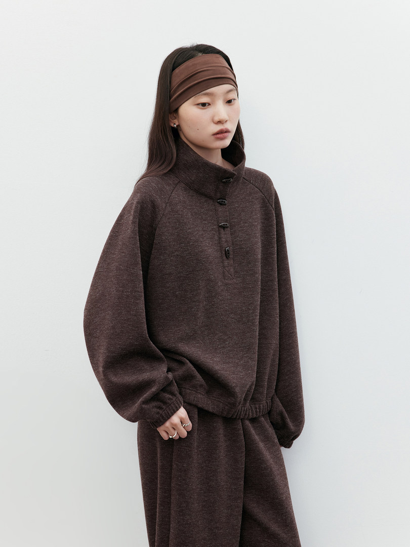 Model wearing a brown oversized matching loungewear set with a headband