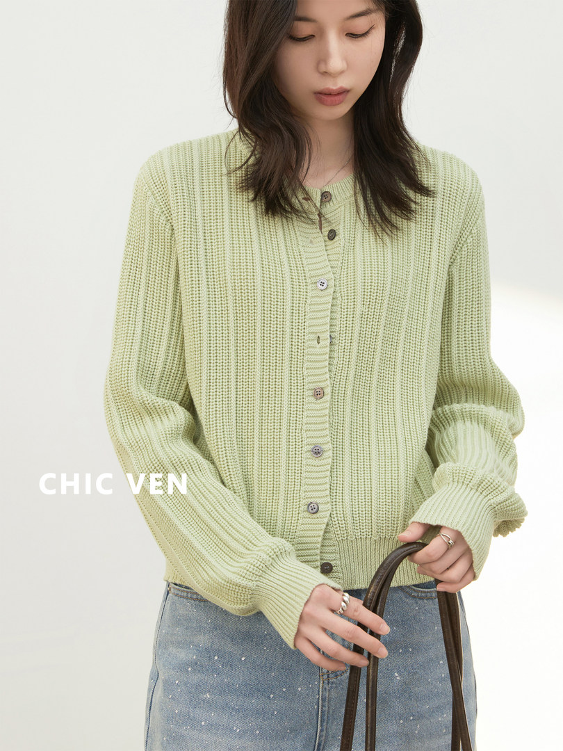 Model wearing a light green knit cardigan sweater with buttons