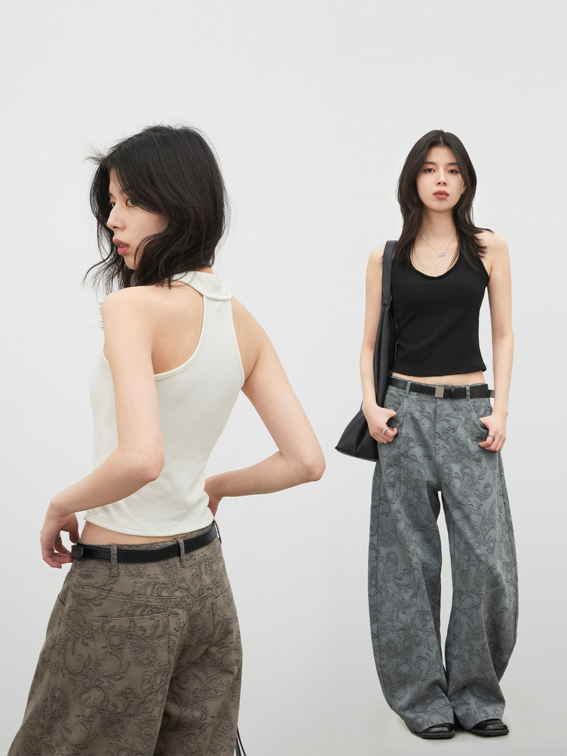 Model wearing patterned wide-leg pants and fitted tank top