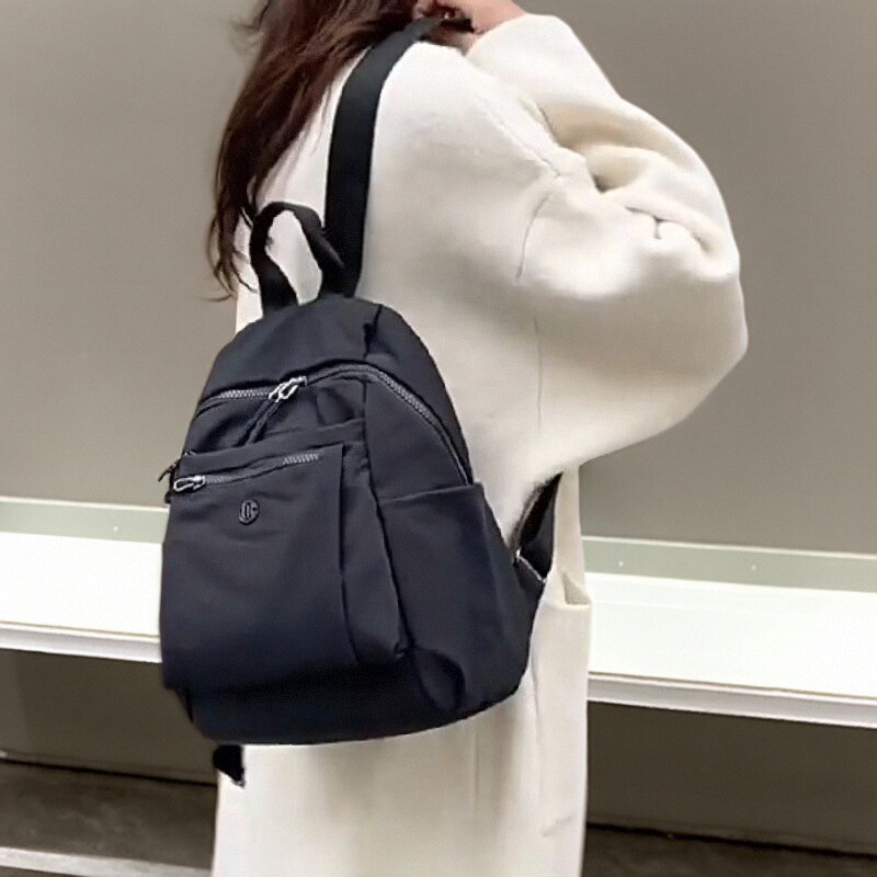 2025质量好铆钉字母防泼水布艺水杯位多袋男女游玩双肩背平板伞包