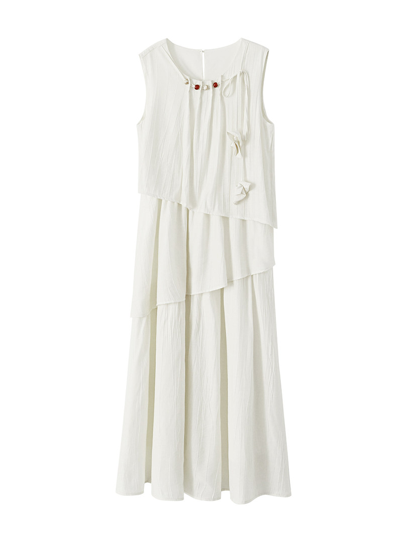 White sleeveless tiered dress on a plain background