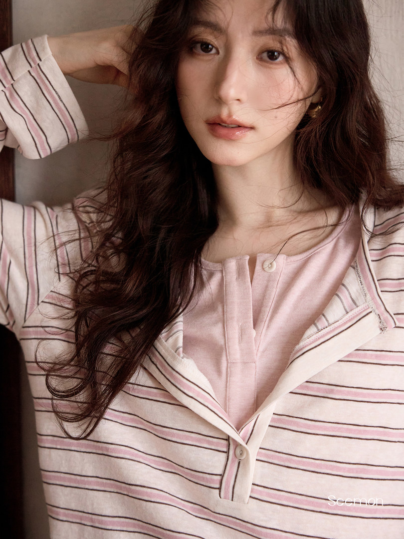 Woman wearing a pink striped button-front loungewear top