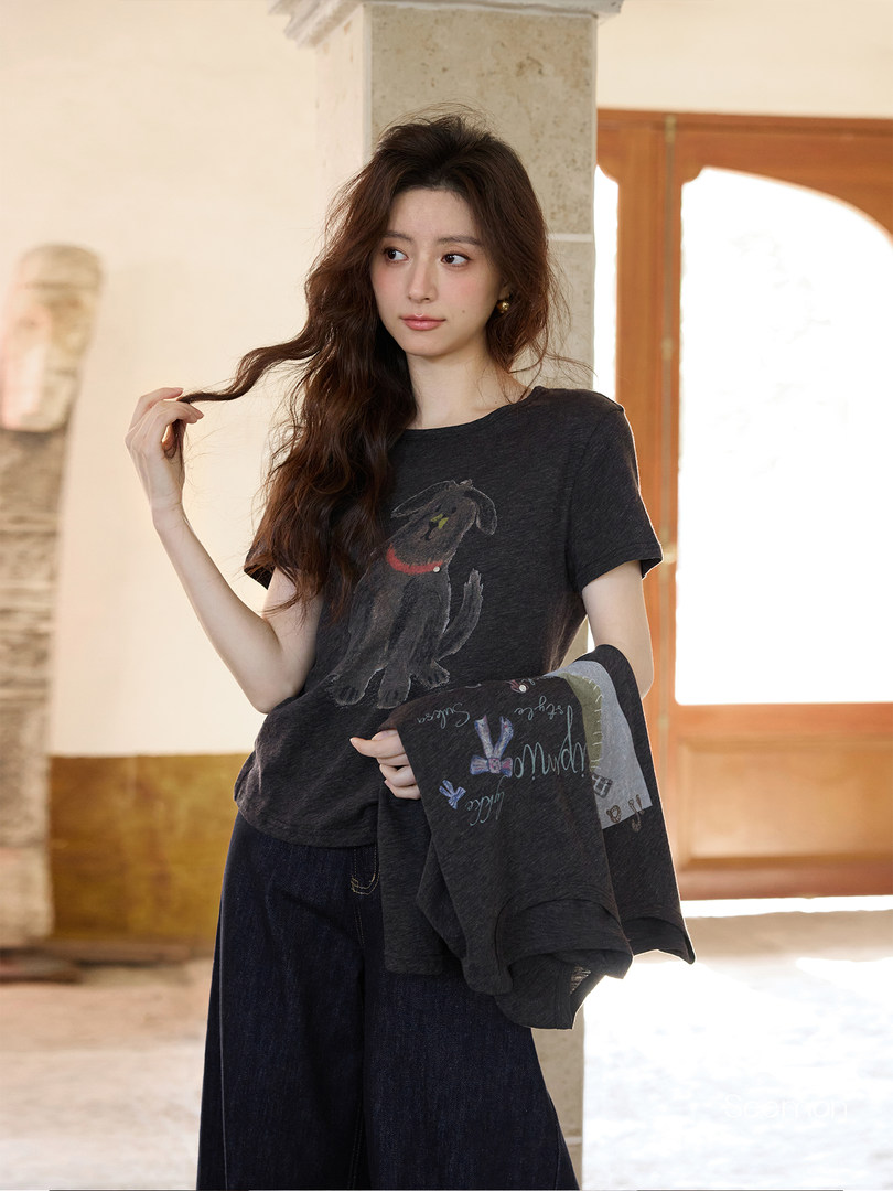 Model wearing a dark graphic t-shirt and wide-leg pants