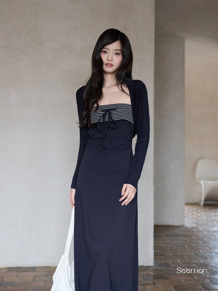 Black long-sleeve striped bodice maxi dress worn by a model