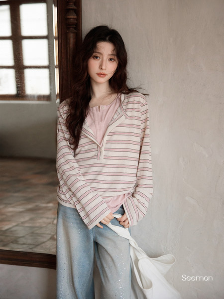 Woman wearing a pink striped loungewear top with light blue pants