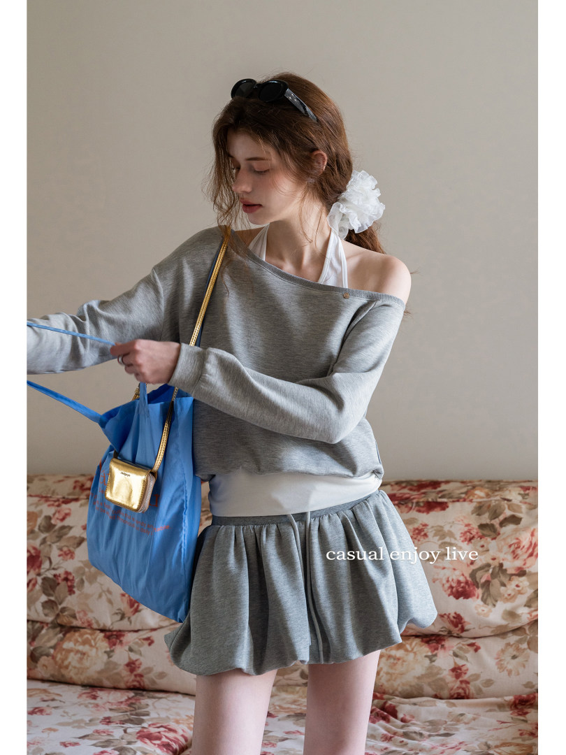 Model wearing a gray off-shoulder loungewear set with shorts