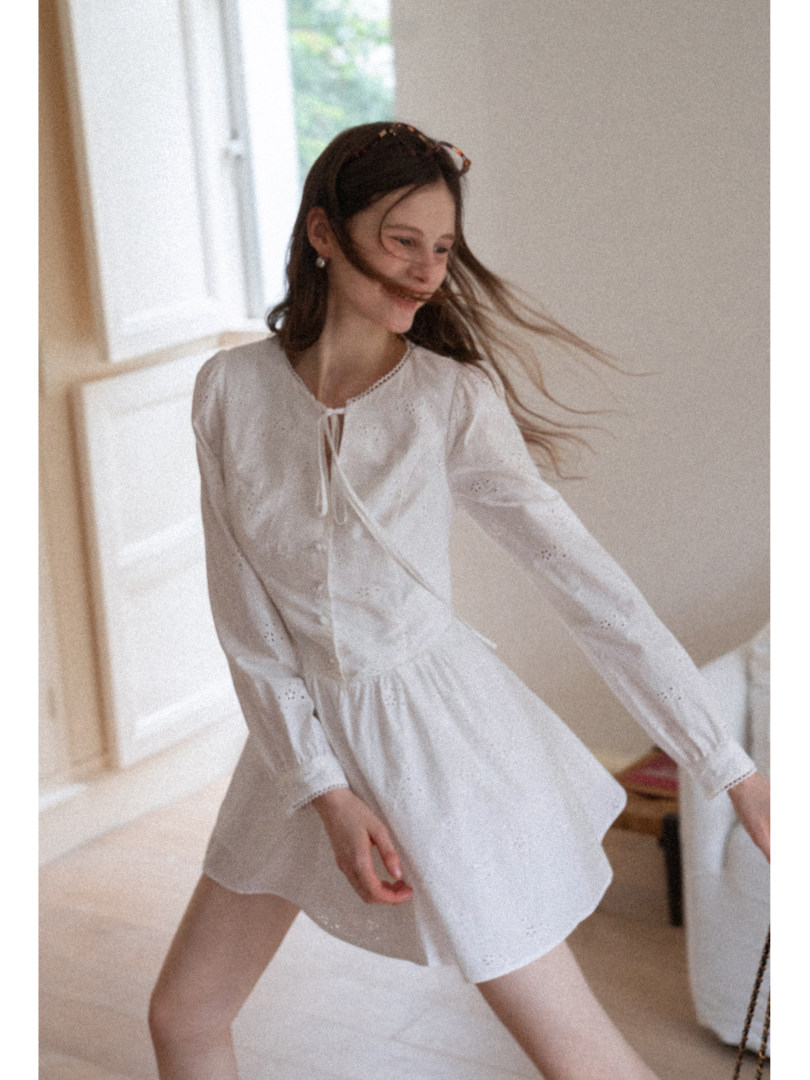 Woman wearing a white lightweight long-sleeve dress