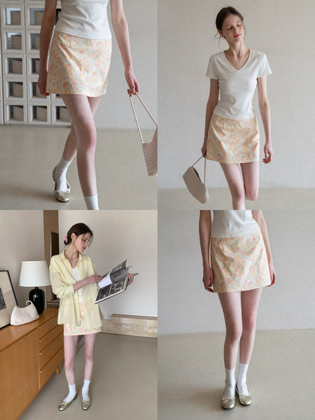 Model wearing a pastel floral mini skirt with a white V-neck top