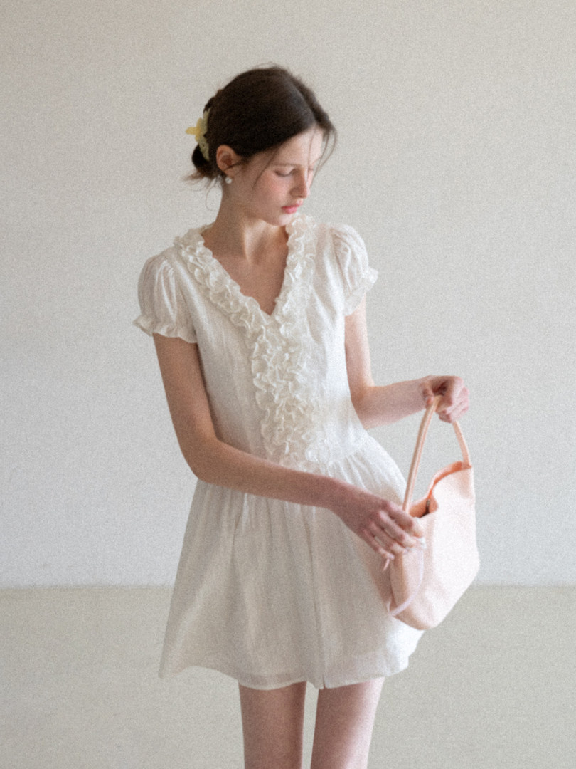 White ruffled short-sleeve dress worn by a model
