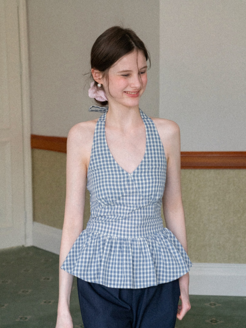 Woman wearing a blue gingham halter top