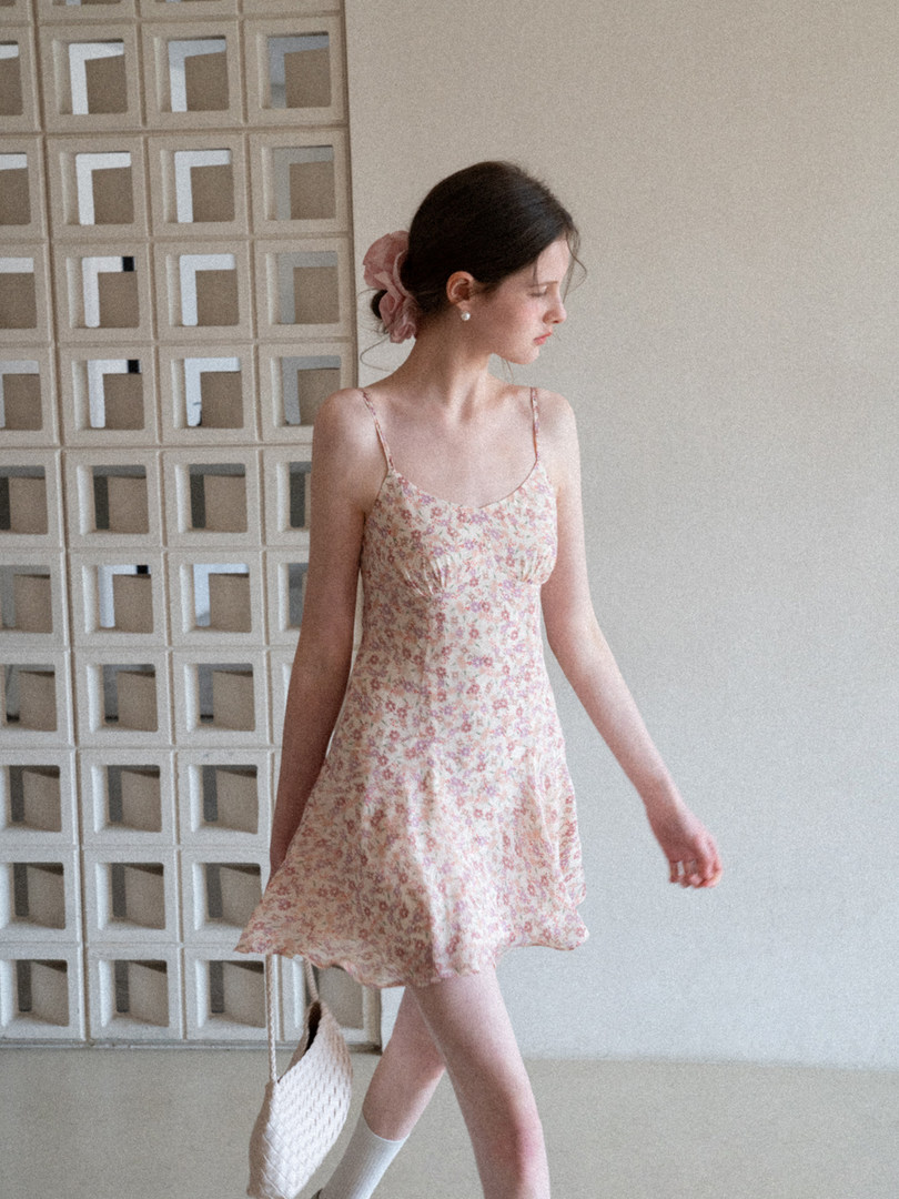 Model wearing a pink floral spaghetti-strap dress