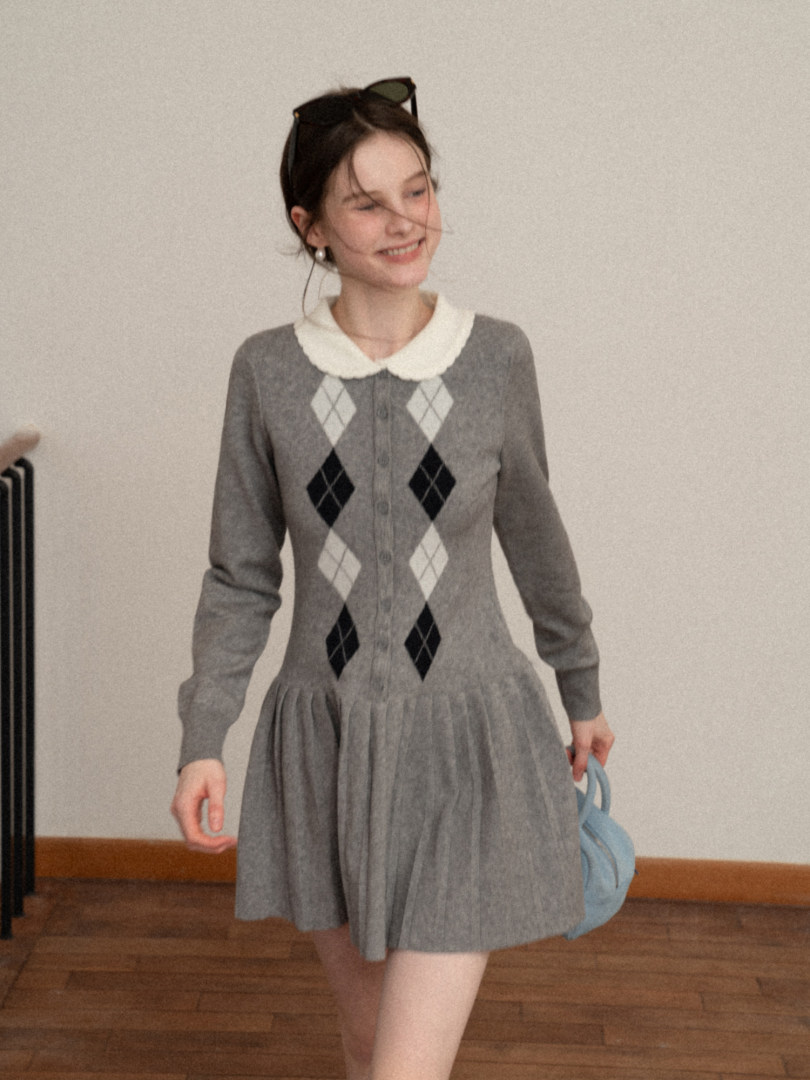 Woman wearing a gray argyle long-sleeve dress with a white collar
