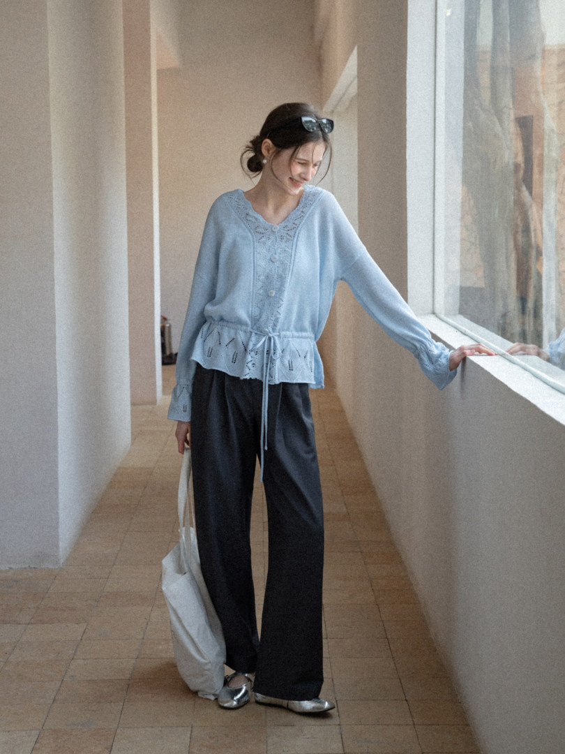 Light blue long-sleeve blouse with lace detail worn with dark trousers