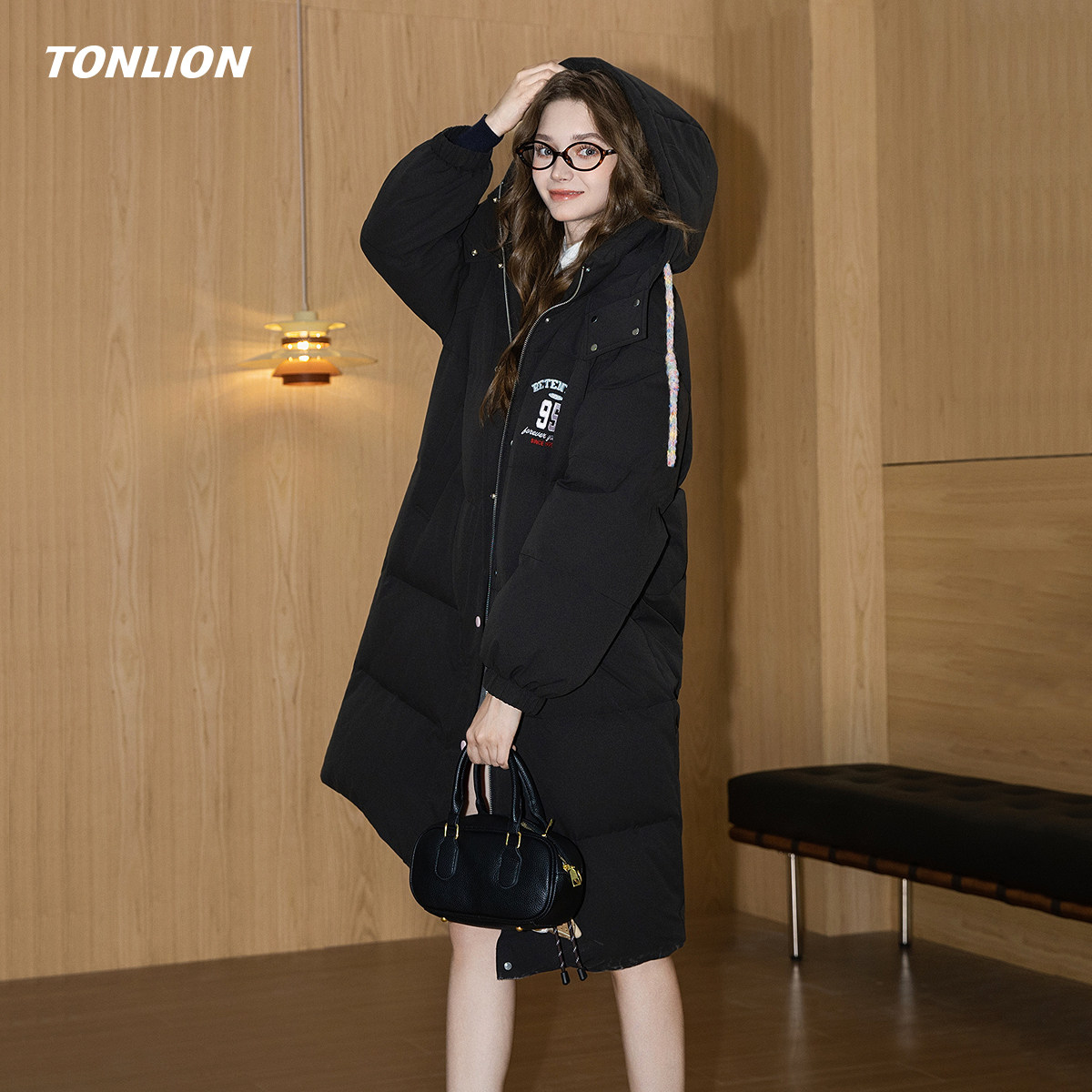 唐狮黑色加厚羽绒服女2025冬季新款韩版宽松连帽长款过膝保暖外套