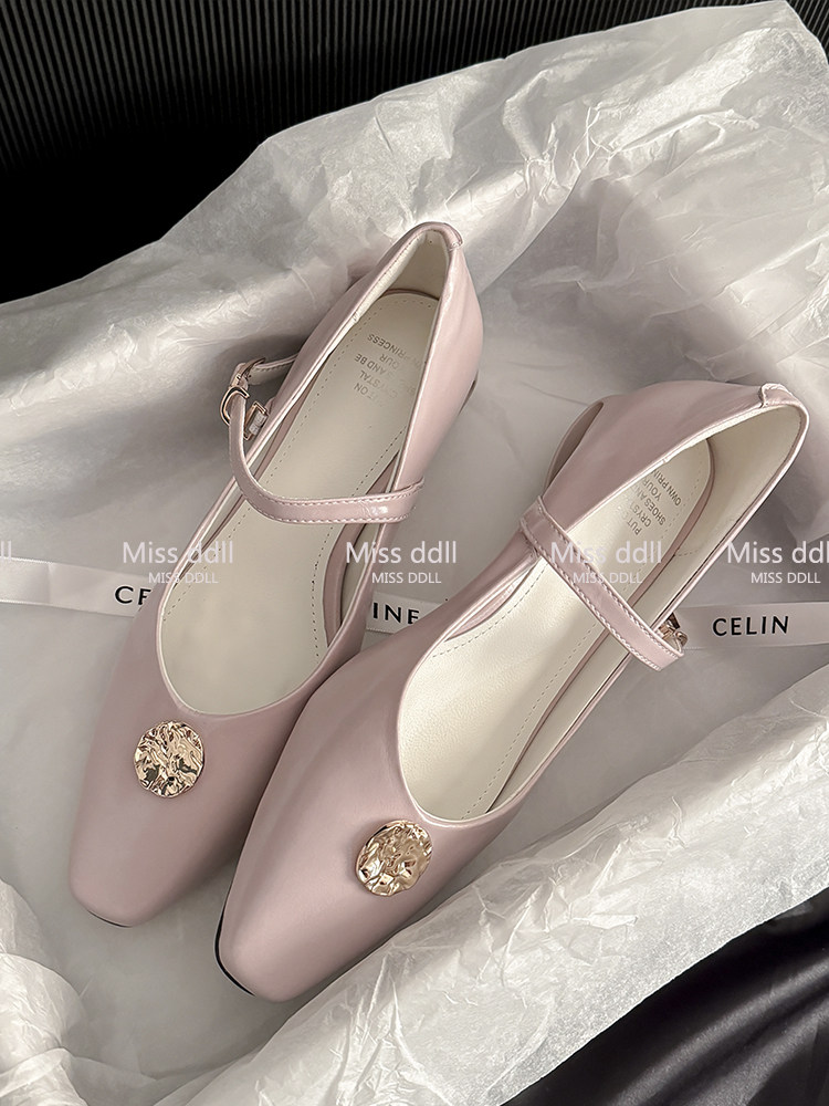 Pair of pink Mary Jane flats with gold decorative accents