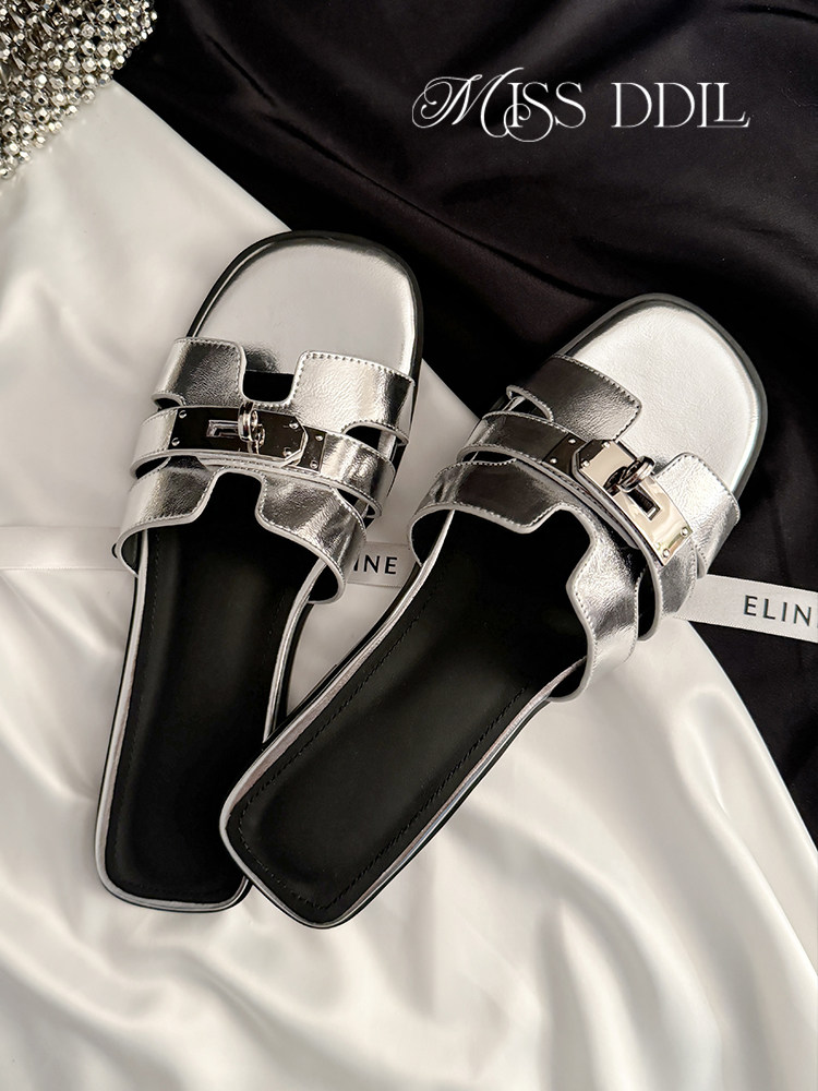 Silver metallic slip-on sandals with buckle detail