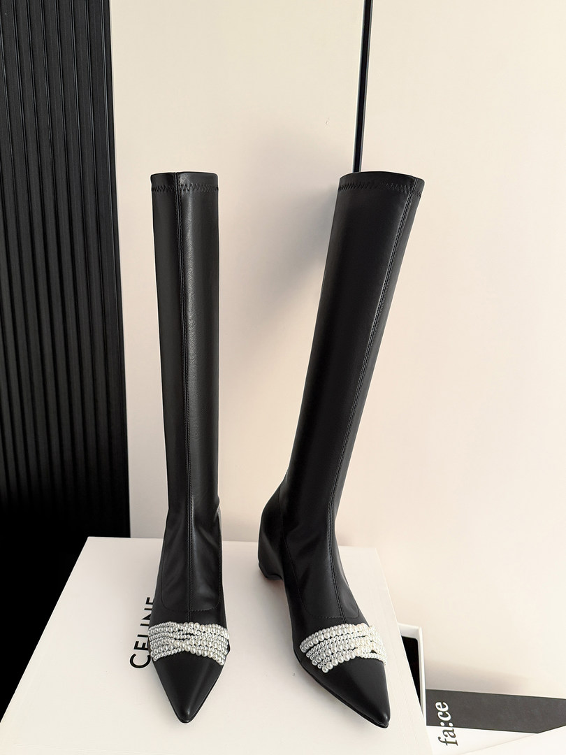 Black over-the-knee pointed-toe boots with crystal embellishment