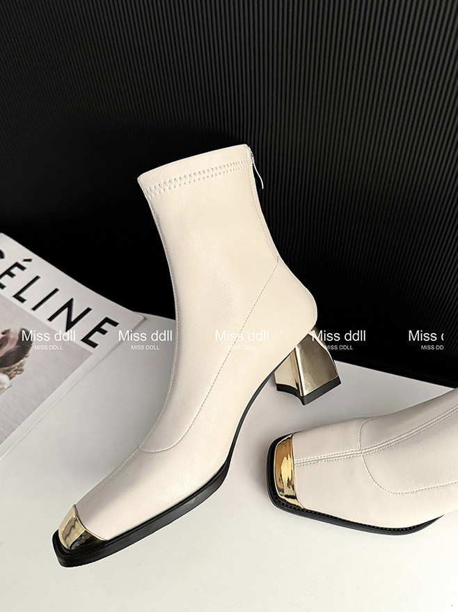 Cream ankle boots with metallic gold toe and heel details