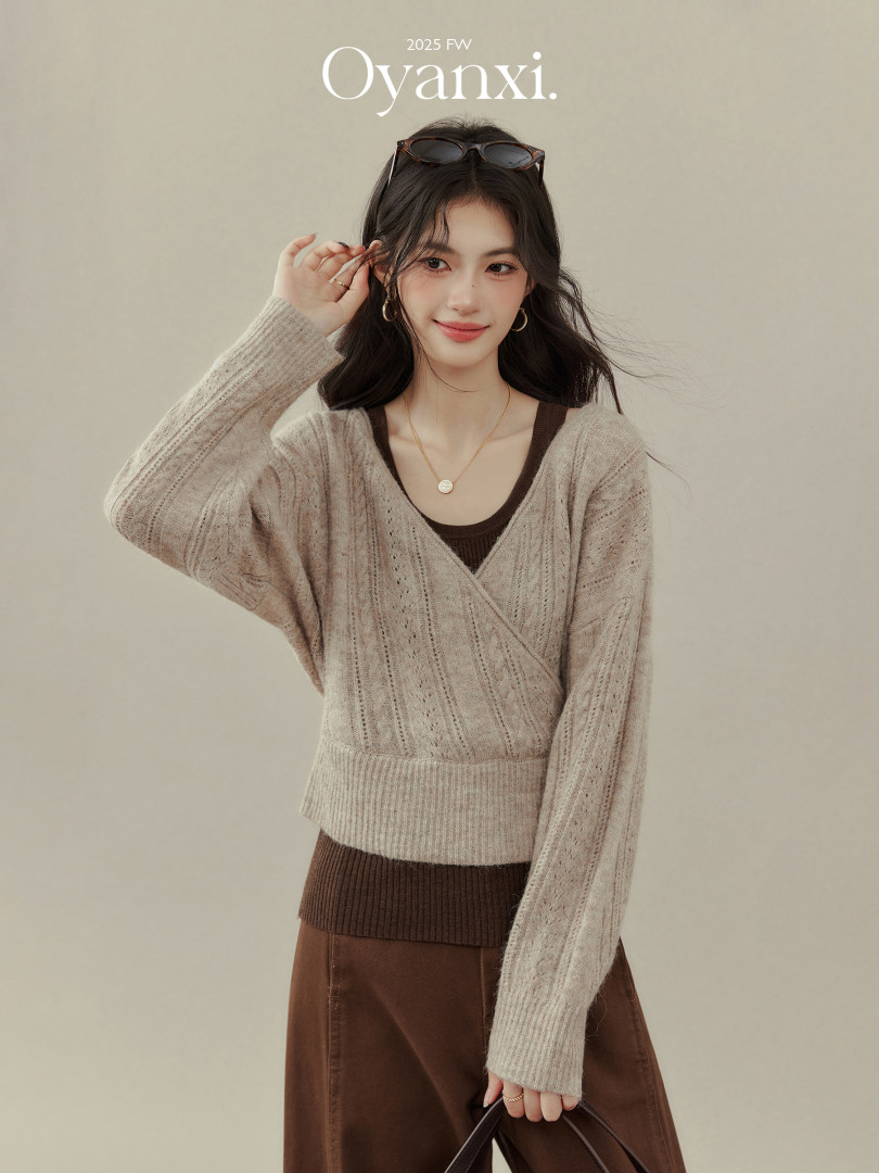 Woman wearing a beige knit wrap sweater with a brown outfit