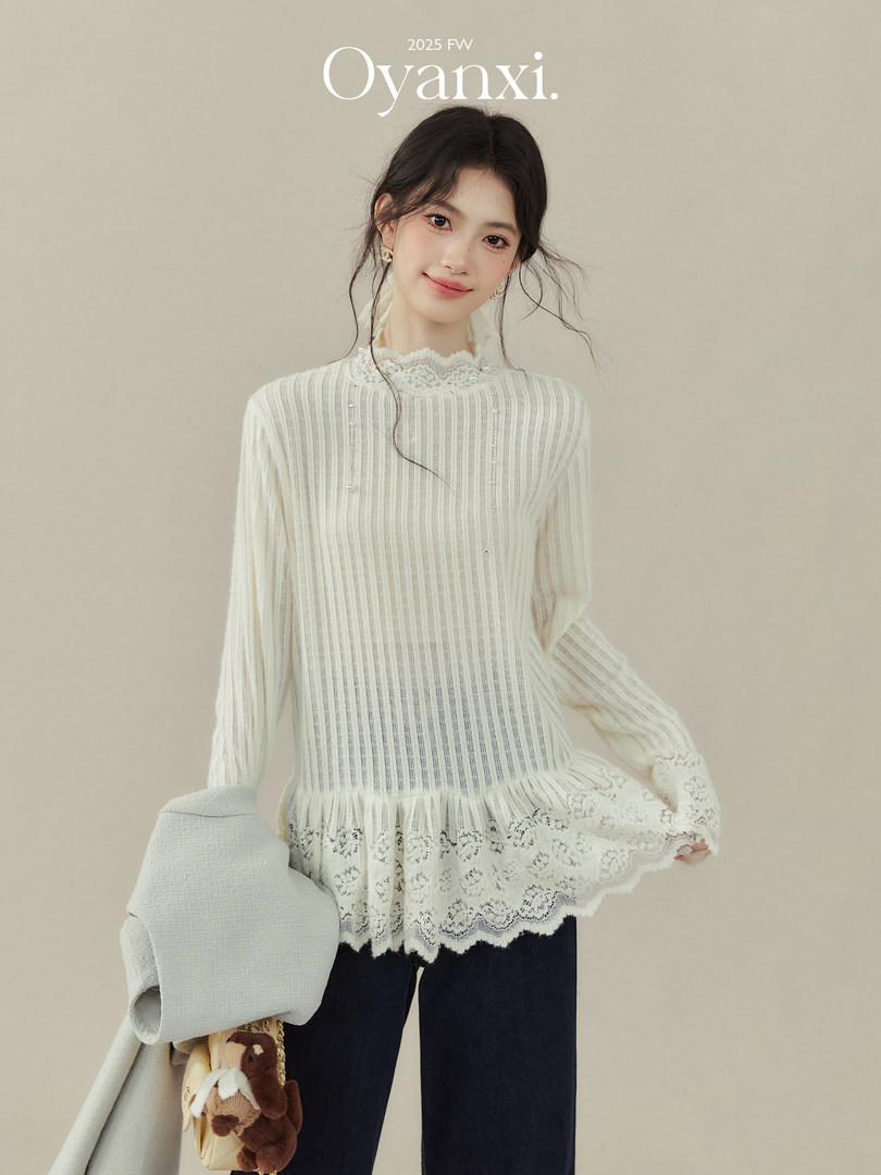Model wearing a cream lace-trimmed long-sleeve blouse and dark pants
